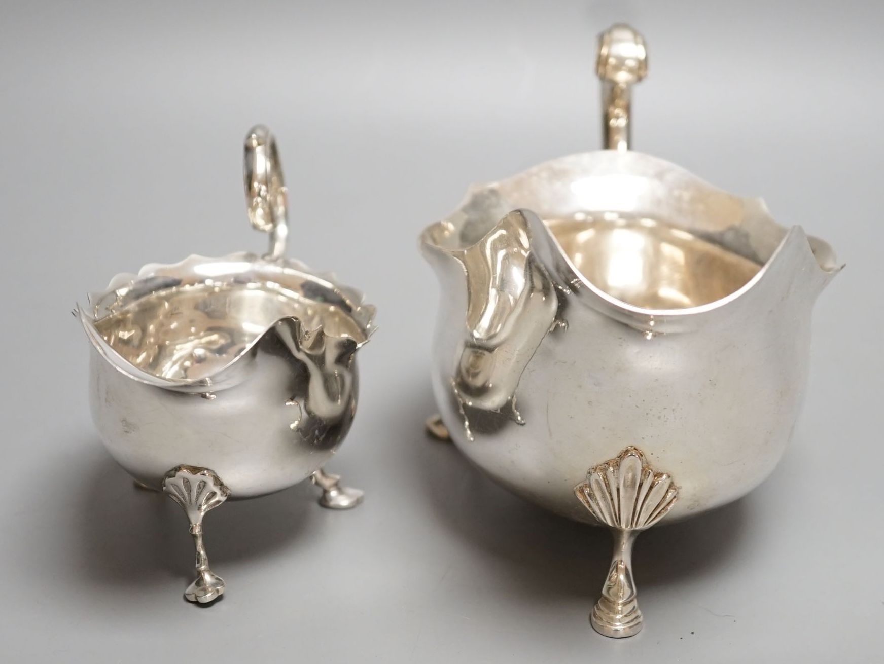 A modern silver sauceboat by Roberts & Belk and a smaller earlier silver sauceboat, 14.5oz.